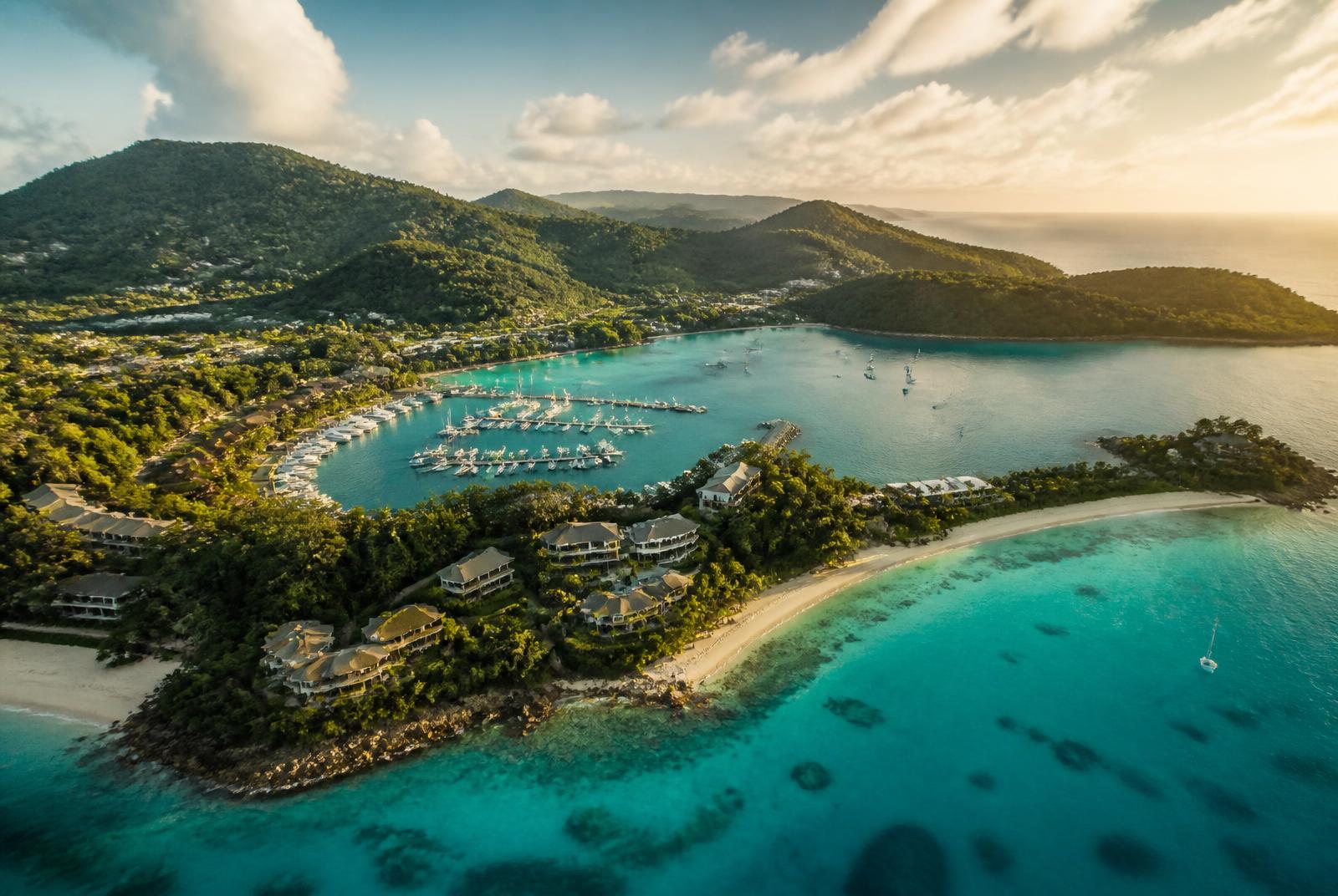 Aerial view of Hamilton Island marina and turquoise Whitsundays water at golden hour